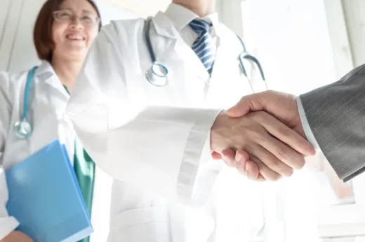 Physician and consultant shaking hands after a meeting